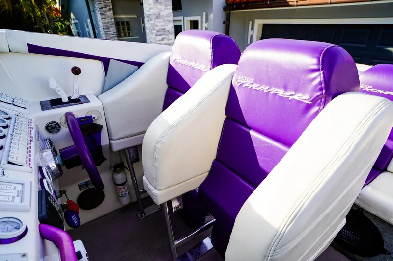 Slide: The Image of Interior of a 2000 Active Thunder 32 boat with purple and white seating. - 10