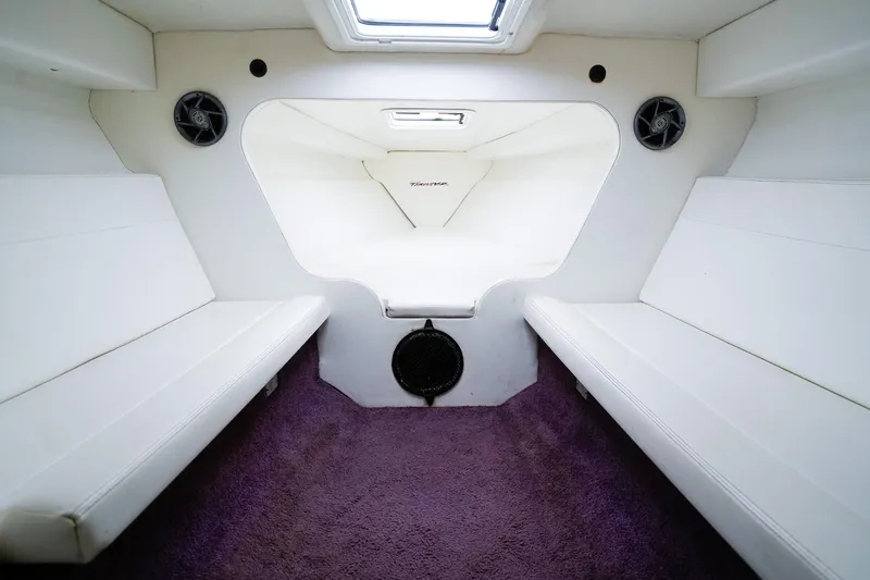 Slide: The Image of Interior of a 2000 Active Thunder 32 boat with white seating and purple carpet. - 12