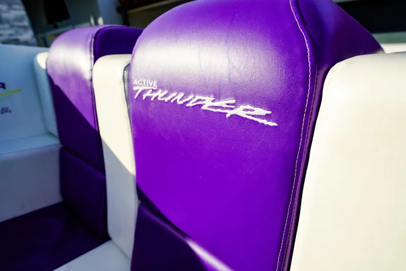 Slide: The Image of Purple and white seating with "Active Thunder" logo on a 2000 Active Thunder 32 boat. - 4