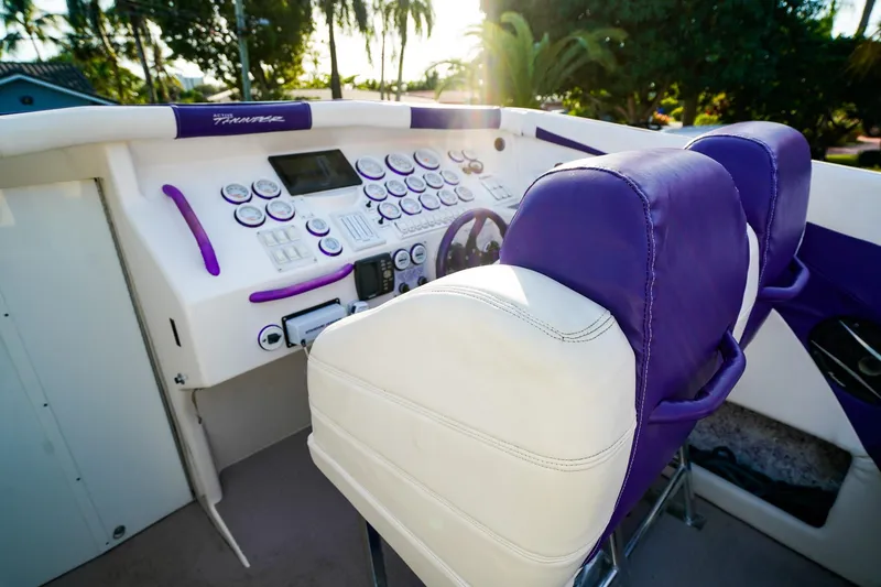 Slide: The Image of Cockpit of a 2000 Active Thunder 32 boat with purple and white seating. - 7