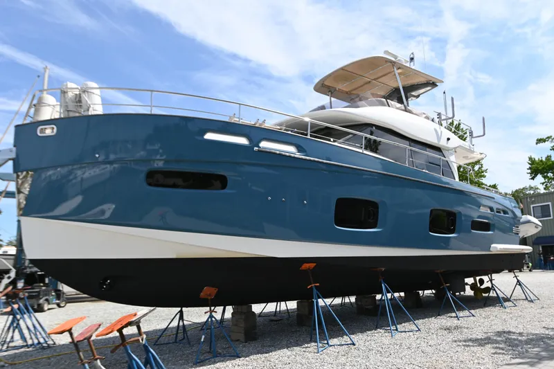 Slide: The Image of 2014 Azimut Magellano 50 yacht on stands, blue hull, outdoor setting. - 1