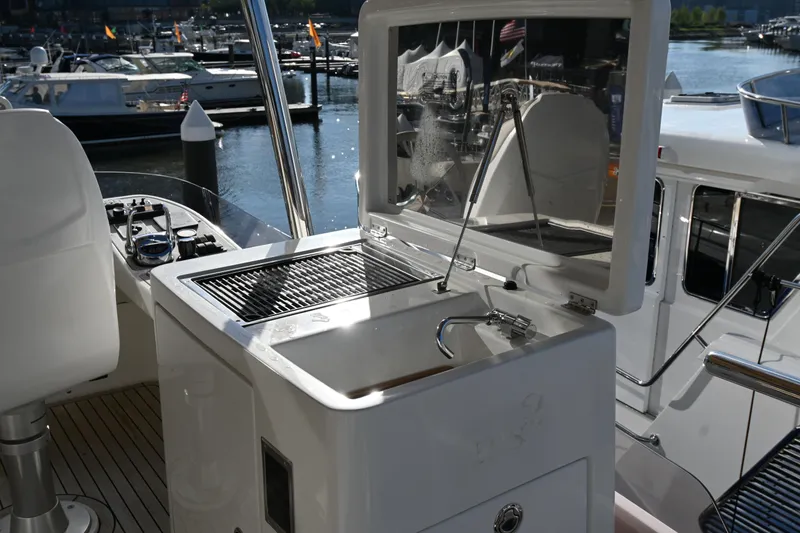 Slide: The Image of Outdoor kitchen on 2014 Azimut Magellano 50 yacht, featuring sink and grill. - 11
