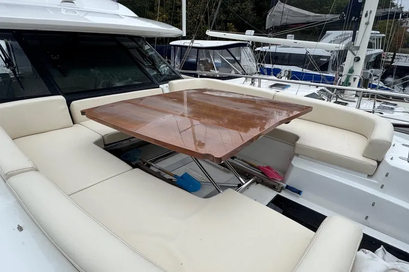 Slide: The Image of Luxurious seating area on 2014 Azimut Magellano 50 yacht with wooden table. - 12