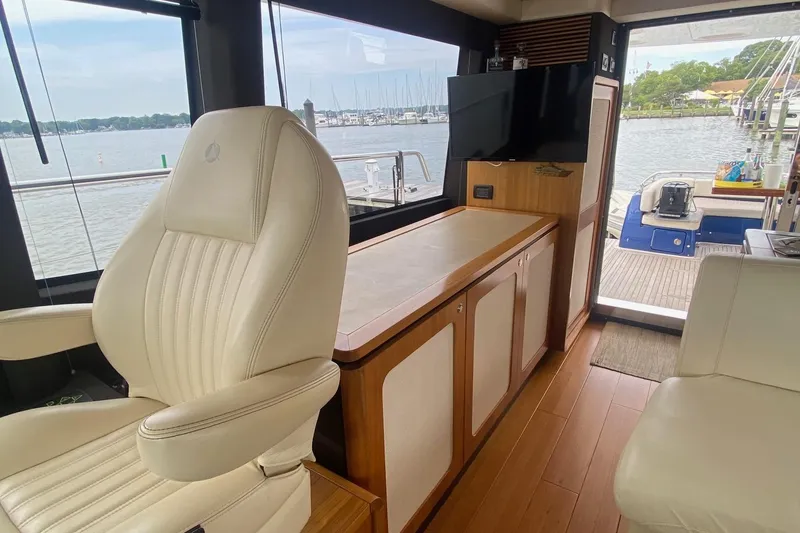 Slide: The Image of Interior of 2014 Azimut Magellano 50 yacht with elegant seating and scenic water view. - 14