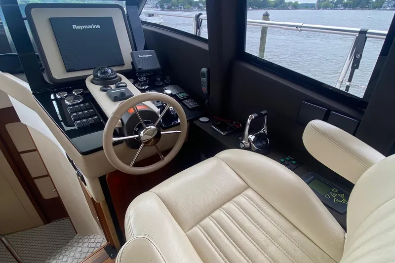 Slide: The Image of 2014 Azimut Magellano 50 yacht helm with Raymarine navigation system and leather seating. - 15