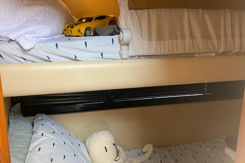 Slide: The Image of Bunk beds in 2014 Azimut Magellano 50 yacht cabin with toy car and plush toy. - 28