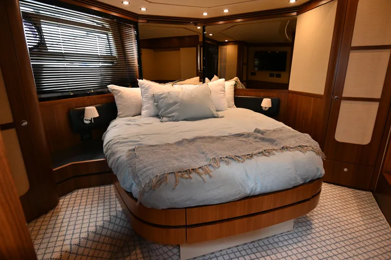 Slide: The Image of Luxurious bedroom interior of 2014 Azimut Magellano 50 yacht with cozy bedding and elegant wood finishes. - 29