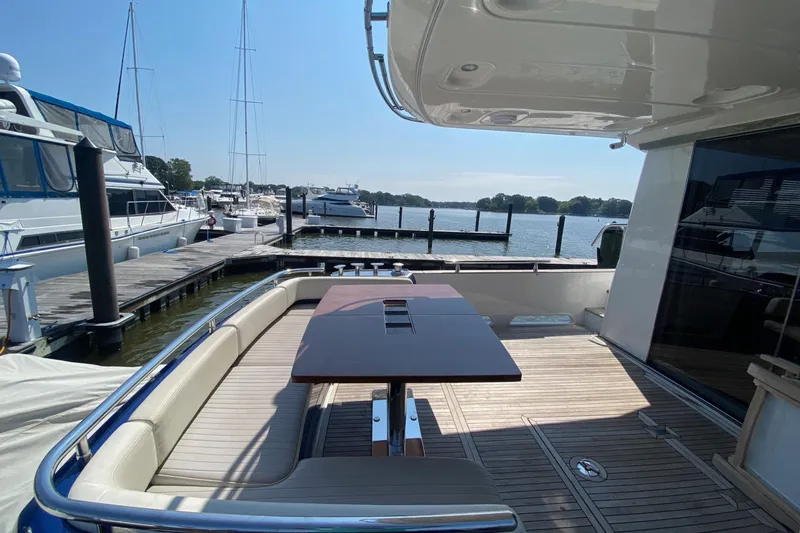 Slide: The Image of Luxurious 2014 Azimut Magellano 50 yacht deck with seating and table, docked at marina. - 3