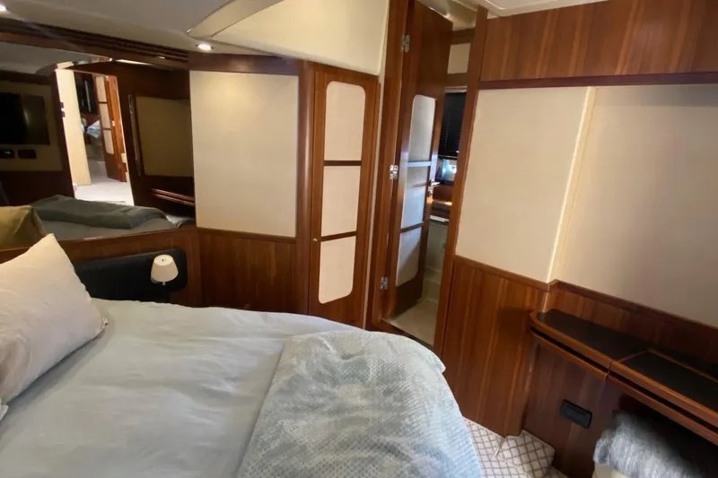 Slide: The Image of Luxurious bedroom interior of 2014 Azimut Magellano 50 yacht with wood paneling and cozy bedding. - 30