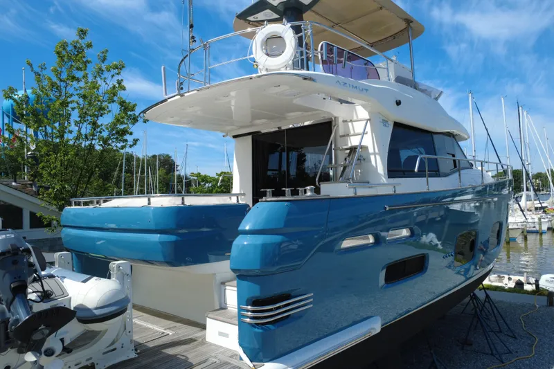 Slide: The Image of 2014 Azimut Magellano 50 yacht docked at marina under clear blue sky. - 7