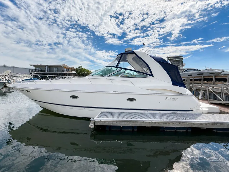 The Image of 2003 Cruisers Yachts 3772 Express docked under a blue sky. - 0