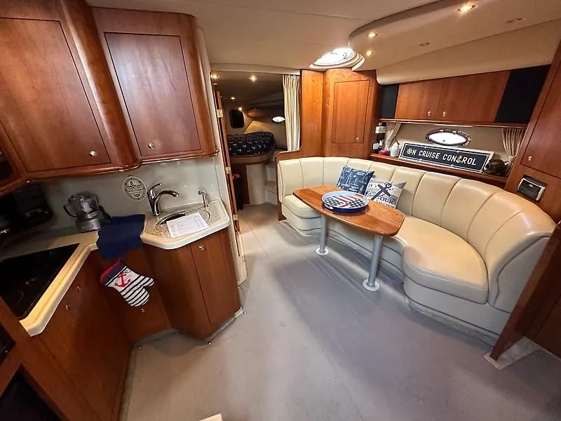 Slide: The Image of Interior of a 2003 Cruisers Yachts 3772 Express with kitchen and seating area. - 14