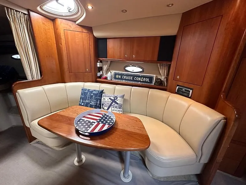 Slide: The Image of Interior of 2003 Cruisers Yachts 3772 Express with cozy seating area. - 16