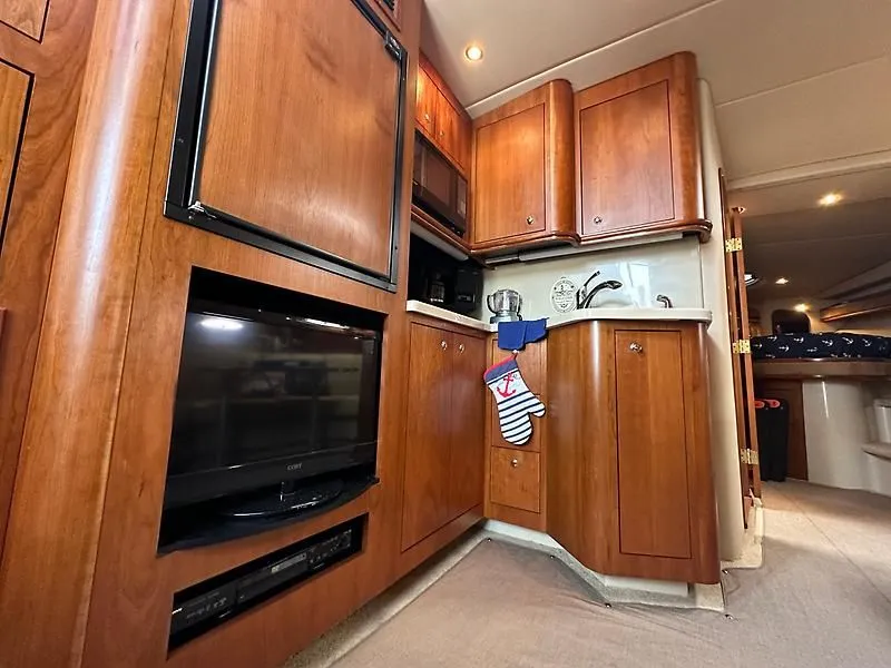 Slide: The Image of Interior of 2003 Cruisers Yachts 3772 Express with wooden cabinetry. - 19