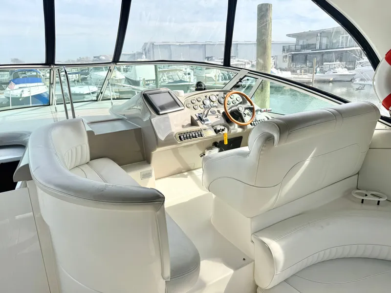 Slide: The Image of Interior of a 2003 Cruisers Yachts 3772 Express with white leather seating. - 6