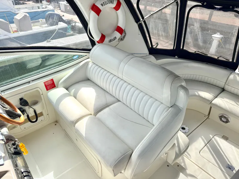 Slide: The Image of Interior of a 2003 Cruisers Yachts 3772 Express with white leather seating. - 9