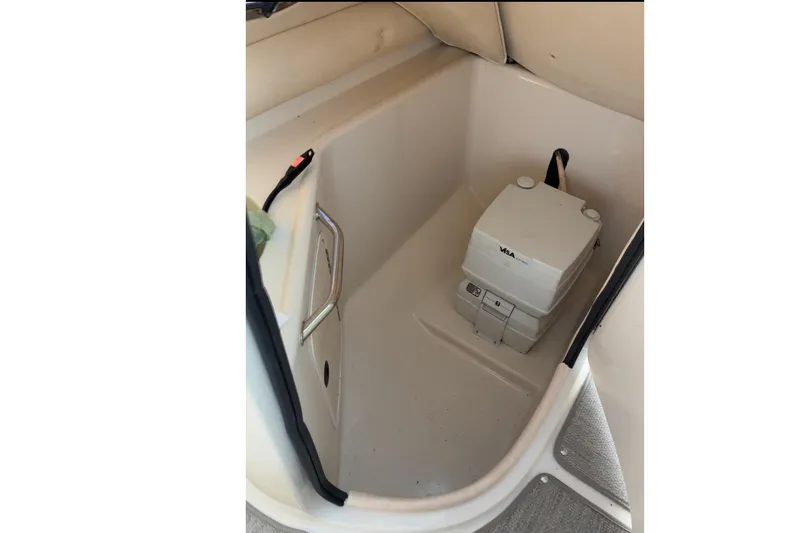 Slide: The Image of Interior of 2004 Sea Ray 240 Sundeck with portable toilet in storage compartment. - 3