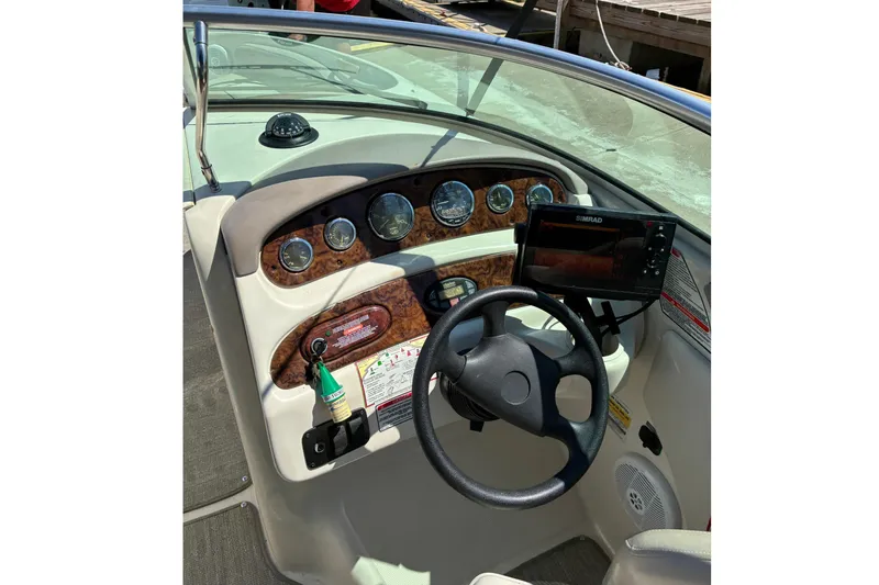 Slide: The Image of 2004 Sea Ray 240 Sundeck boat helm with Simrad display. - 5