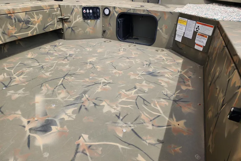 Slide: The Image of 2022 GRIZZLEY 1654SPT boat interior with camouflage pattern and control panel. - 6