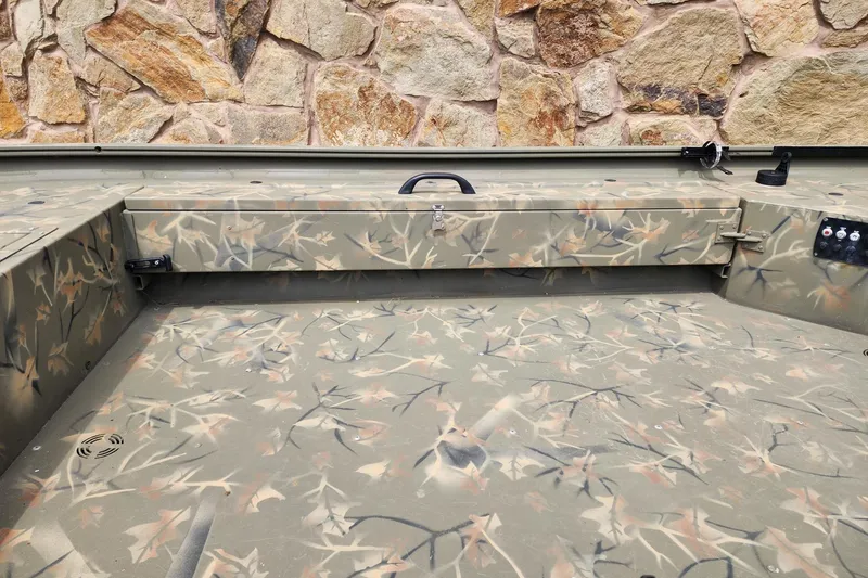 Slide: The Image of 2022 GRIZZLEY 1654SPT boat interior with camouflage pattern and stone wall background. - 7