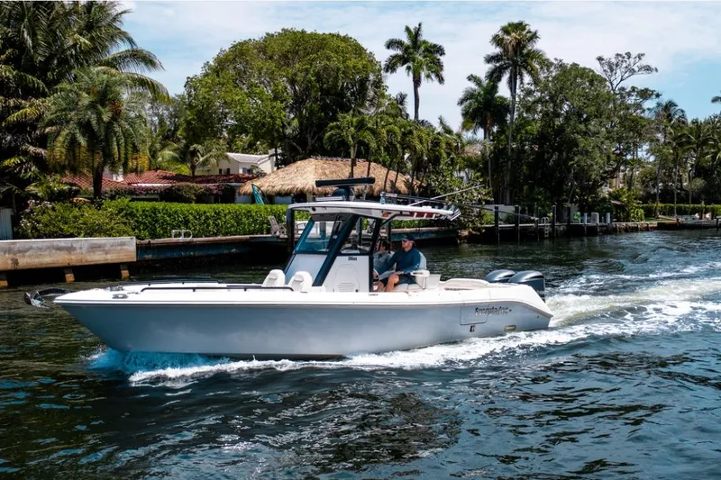 Slide: The Image of 2021 Everglades 295 Center Console boat cruising on a scenic waterway. - 0