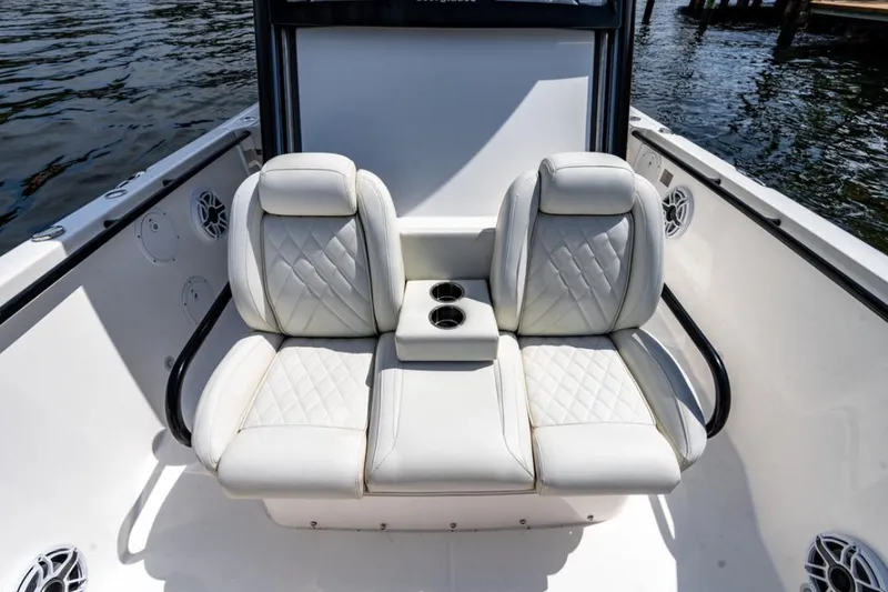 Slide: The Image of 2021 Everglades 295 Center Console boat docked, featuring dual engines and fishing rod holders. - 15