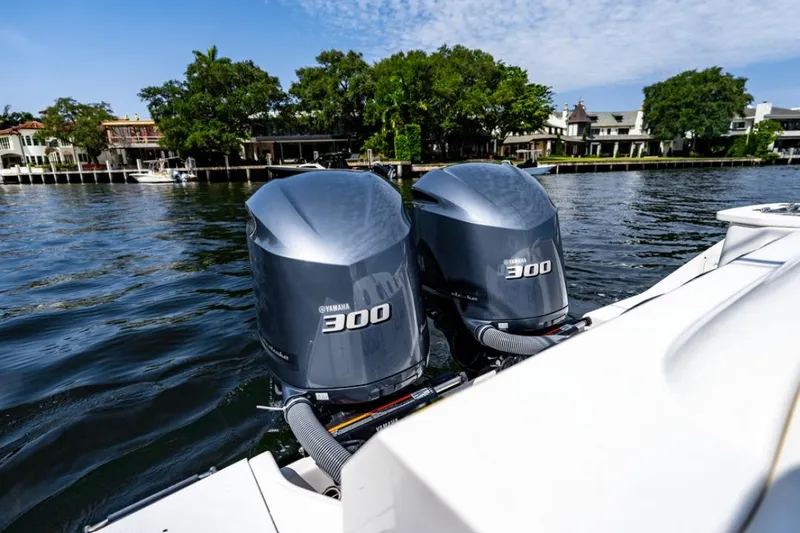 Slide: The Image of 2021 Everglades 295 Center Console boat dashboard with navigation screens and steering wheel. - 6