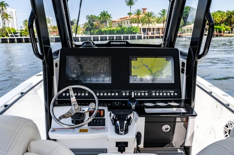 Slide: The Image of 2021 Everglades 295 Center Console boat interior with luxurious seating and advanced navigation controls. - 8