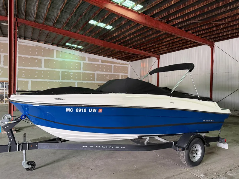 Slide: The Image of 2023 Bayliner VR4 Bowrider boat in warehouse. - 0