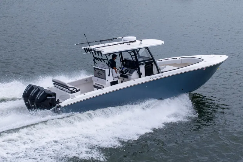 The Image of 2024 Fountain Bluewater 34 Tournament Edition boat cruising on water. - 1