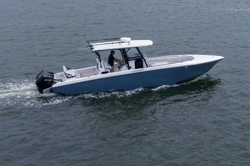Slide: The Image of 2024 Fountain Bluewater 34 Tournament Edition boat cruising on open water. - 11