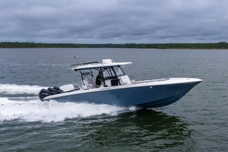 Slide: The Image of 2024 Fountain Bluewater 34 Tournament Edition boat cruising on a lake. - 12