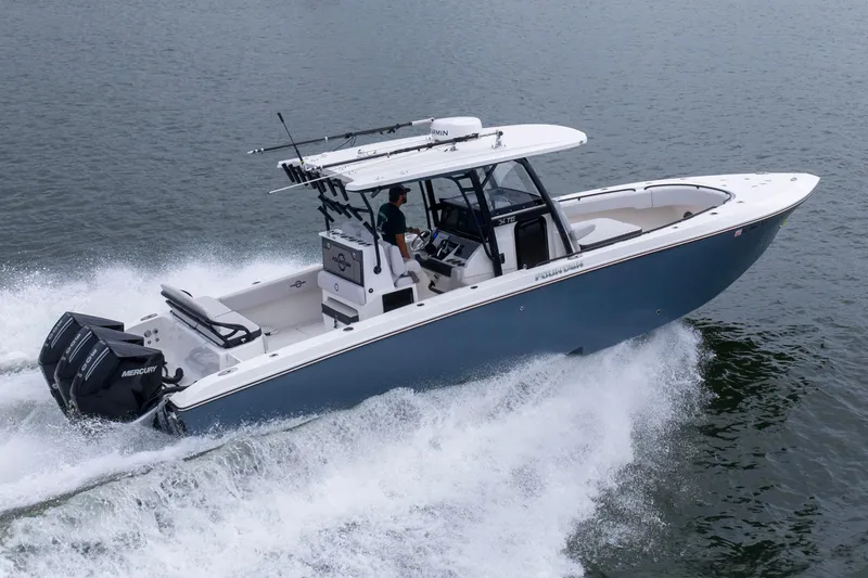 Slide: The Image of 2024 Fountain Bluewater 34 Tournament Edition boat cruising on water. - 13