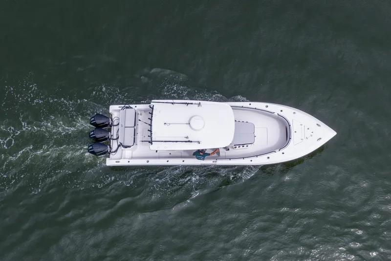 Slide: The Image of Aerial view of 2024 Fountain Bluewater 34 Tournament Edition boat cruising on water. - 14