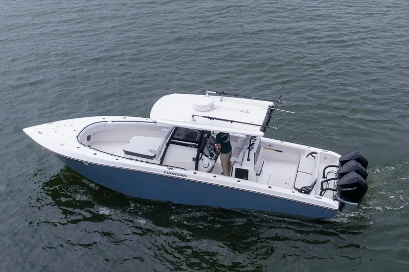 Slide: The Image of 2024 Fountain Bluewater 34 Tournament Edition boat cruising on open water. - 16