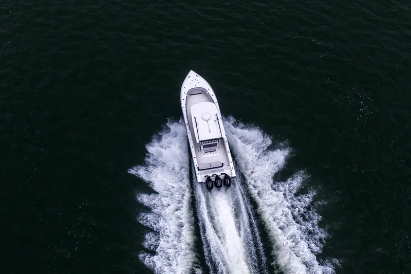 Slide: The Image of Aerial view of 2024 Fountain Bluewater 34 Tournament Edition boat speeding on water. - 17