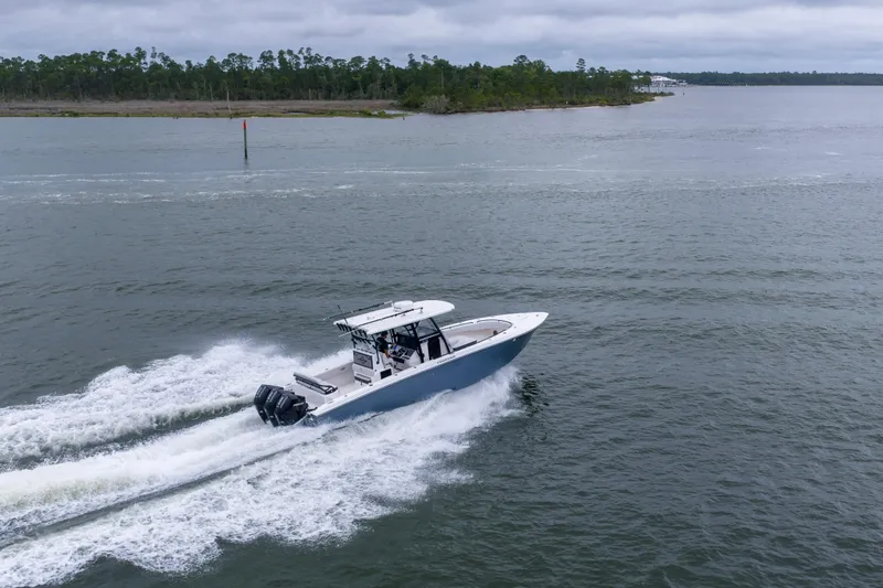 Slide: The Image of 2024 Fountain Bluewater 34 Tournament Edition boat cruising on open water. - 19