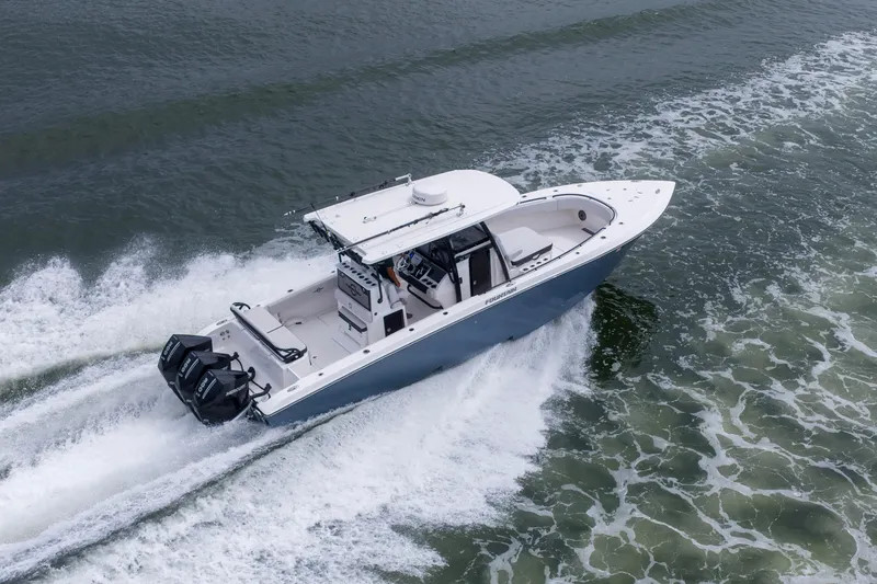 Slide: The Image of 2024 Fountain Bluewater 34 Tournament Edition boat cruising on open water. - 2