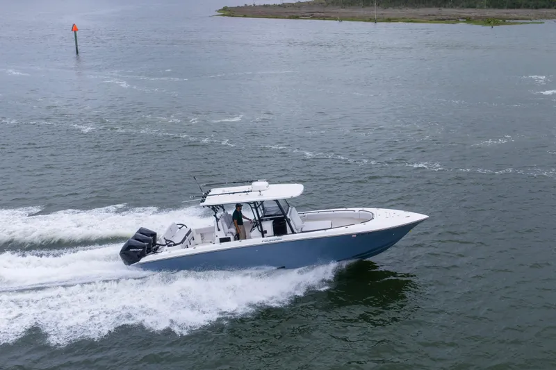 Slide: The Image of 2024 Fountain Bluewater 34 Tournament Edition boat cruising on open water. - 20