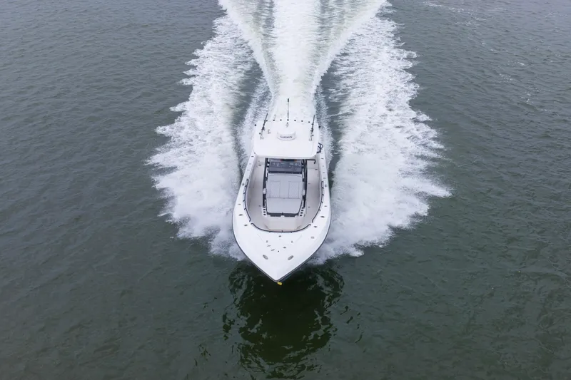 Slide: The Image of 2024 Fountain Bluewater 34 Tournament Edition boat cruising on open water. - 21