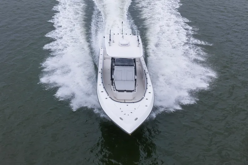 Slide: The Image of 2024 Fountain Bluewater 34 Tournament Edition boat cruising on open water. - 22