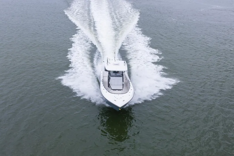 Slide: The Image of 2024 Fountain Bluewater 34 Tournament Edition boat cruising on open water. - 23