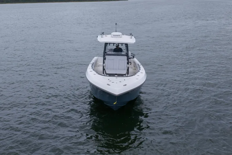Slide: The Image of 2024 Fountain Bluewater 34 Tournament Edition boat on calm water. - 24