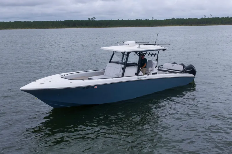 Slide: The Image of 2024 Fountain Bluewater 34 Tournament Edition boat on calm water. - 26