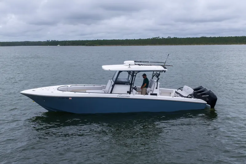 Slide: The Image of 2024 Fountain Bluewater 34 Tournament Edition boat on calm water, overcast sky. - 27