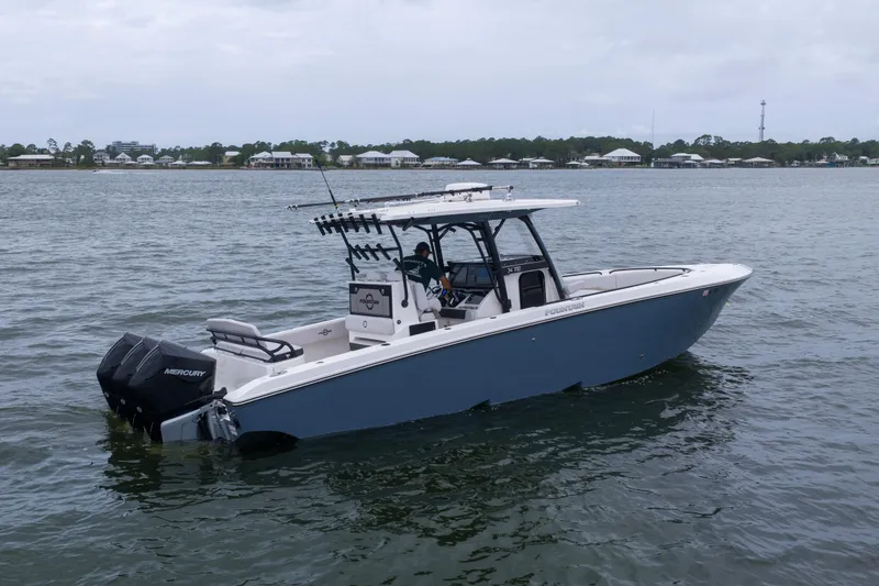 Slide: The Image of 2024 Fountain Bluewater 34 Tournament Edition boat on calm water. - 30