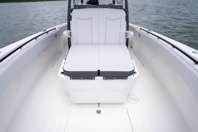 Slide: The Image of 2024 Fountain Bluewater 34 Tournament Edition boat interior with cushioned seating. - 32
