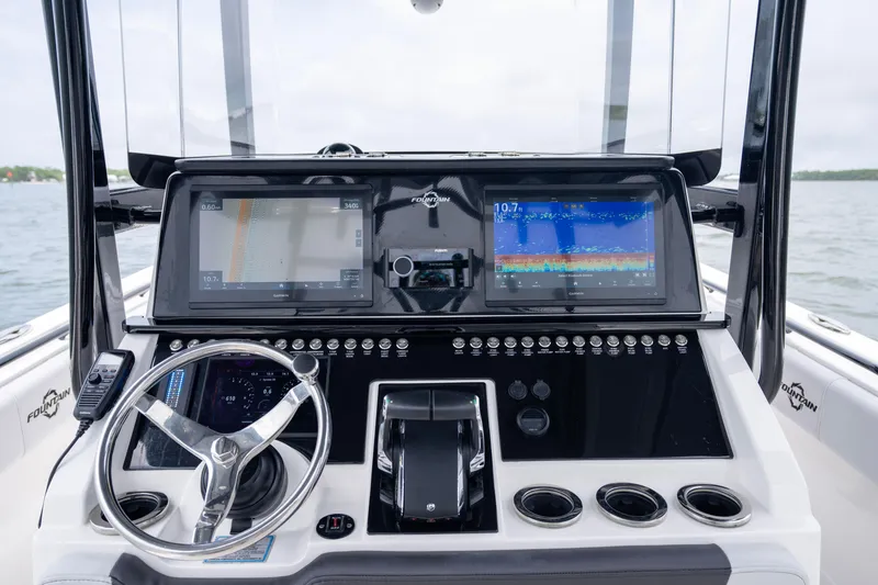 Slide: The Image of 2024 Fountain Bluewater 34 Tournament Edition boat dashboard with advanced navigation displays. - 37