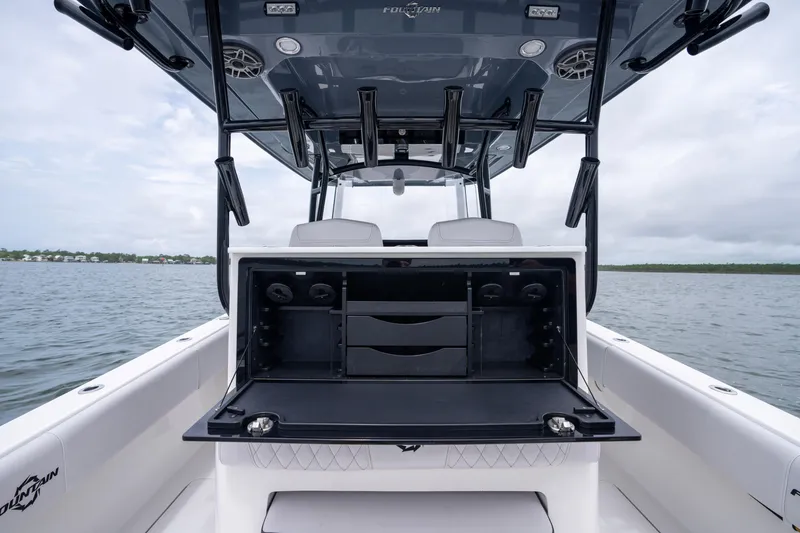 Slide: The Image of 2024 Fountain Bluewater 34 Tournament Edition boat interior with open storage compartment. - 39