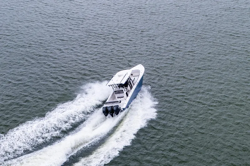 Slide: The Image of 2024 Fountain Bluewater 34 Tournament Edition boat cruising on open water. - 4
